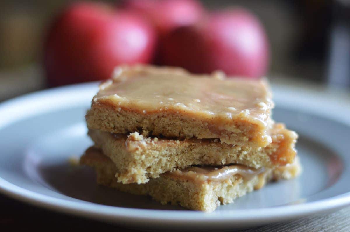 Photo of 3 maple apple bars stacked on top of each other, side view, on gray plate.